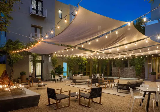Outdoor patio area with a fireplace on the left and skylights