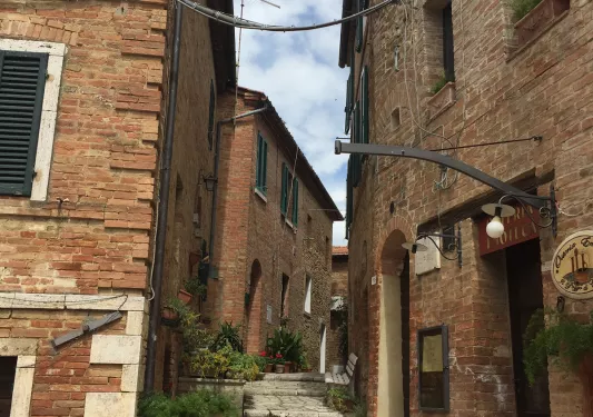 stone pathway in between brick buildings