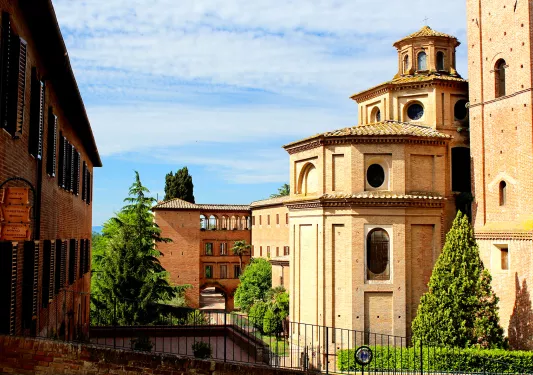 red brick building surrounded by trees and other brick buildings