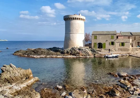 Shore with a cement silo and gray, stone buildings