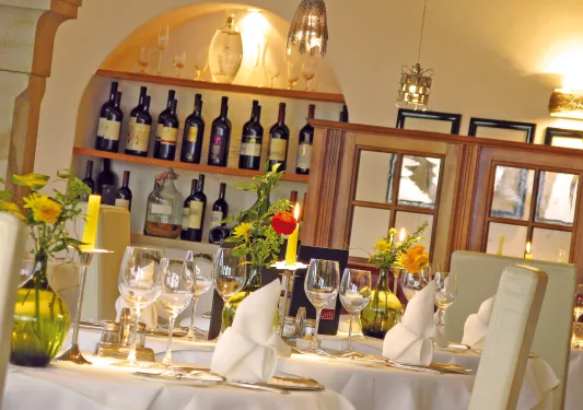 dining room with wine bottles on back wall
