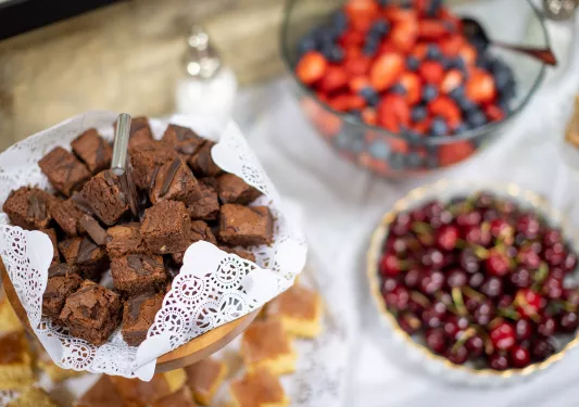 Display of fruit, berries and small brownie bites.