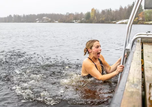 Women jumping into a cold lake