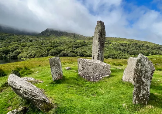 six large rocks in a grassy field