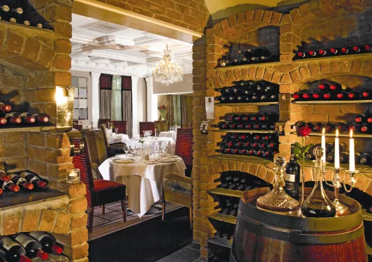 Red brick wine cellar with a dining area in the back