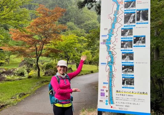 Woman pointing at a Japanese hiking trail map