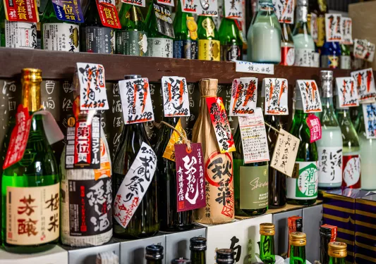 Bottles of alcohol lined up against a wall