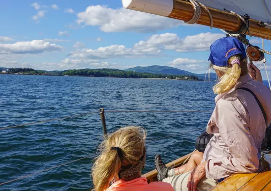 Two women on a boat looking at the sea