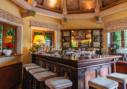 Wooden bar with stools surrounding the bar area