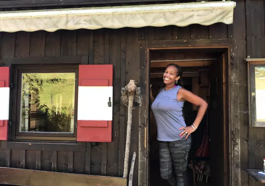 Woman standing in the doorway of a wooden building