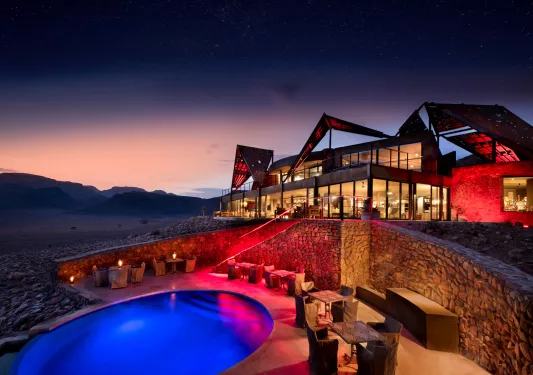 pool and hotel lit up at night