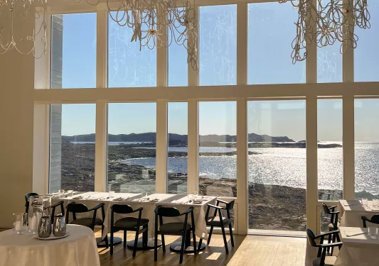 dining room with window overlooking water