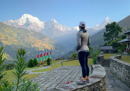 Woman overlooking hills and mountains in the distance