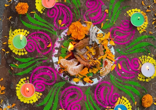 Ritual offerings on a painted ground surrounded by candles