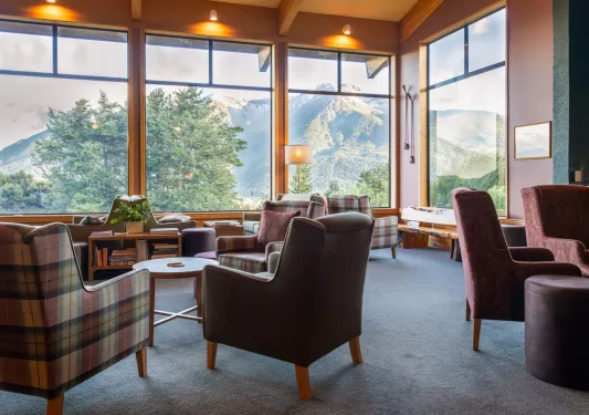 living room with arm chairs and large windows