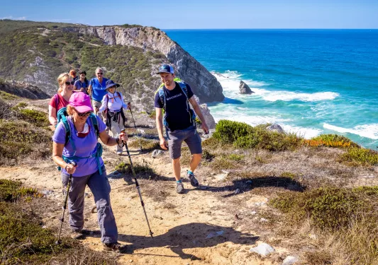 Hikers walking up a shoreline trail