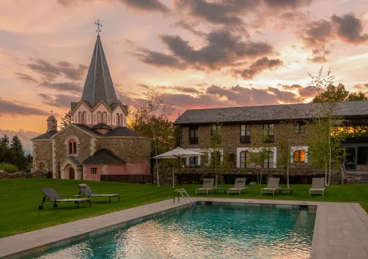Outdoor pool with a castle-like building in the background