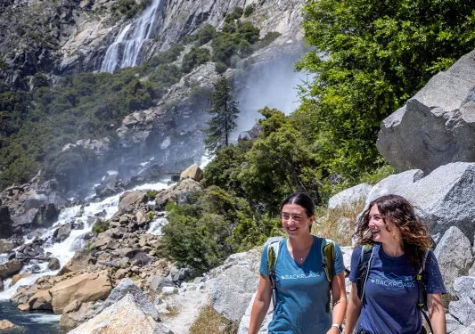 Backroads guest hiking up a rocky slope
