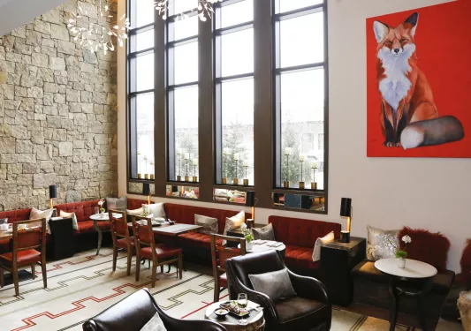 dining room with red couches and large windows