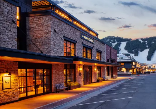 Hotel building made of stone and surrounded by bright orange lights