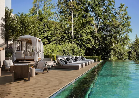 swimming pool with lounge chairs next to it