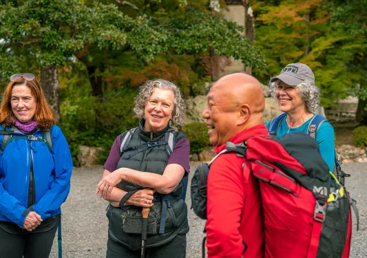 Group of women smiling with a man laughing in front