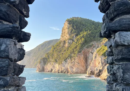 Archway made of stone, looking out towards the ocean
