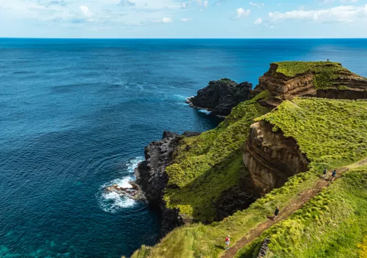 steep cliff over blue water