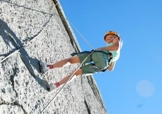 Child belaying from a wall using rope