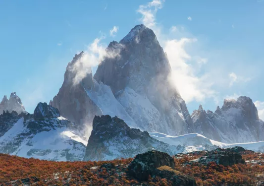 Fog covering snow-capped mountains