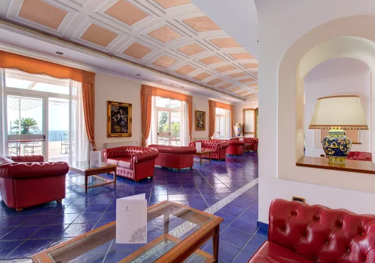Lobby with blue tile flooring and red leather couches