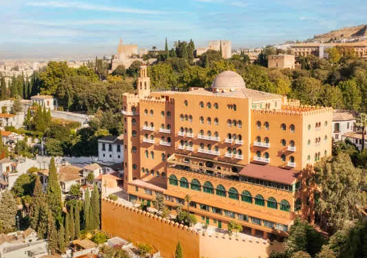 Exterior view of yellow, multi-story hotel building