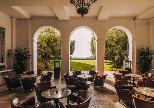 Seating area with large arches leading to an outdoor garden