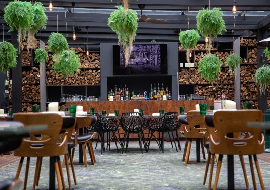 Outdoor dining area with a bar counter in the background