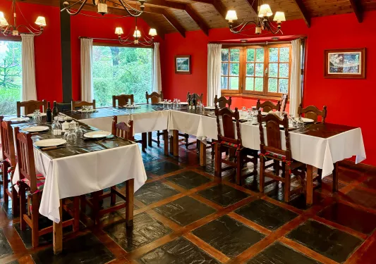 Dining hall with tables shaped in a half circle, with bright red walls