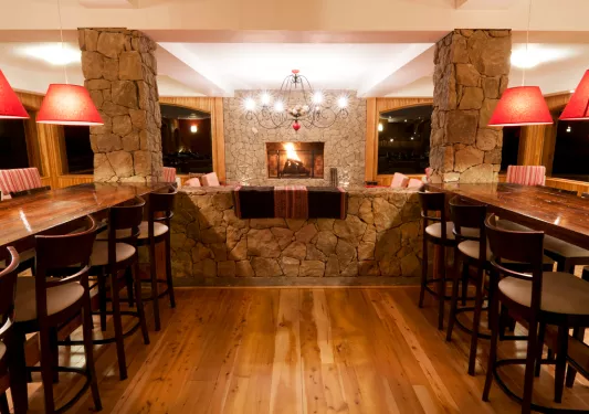 Restaurant with long, wooden tables and tall stools