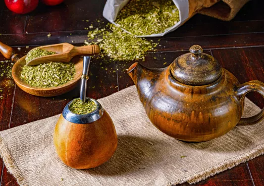 A cup and tea put full of traditional mate drink