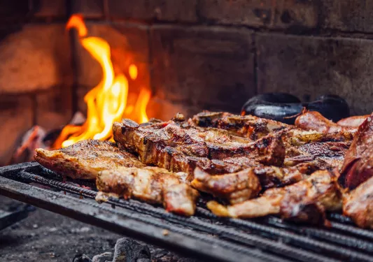 Open barbecue grill with grilled meats on top