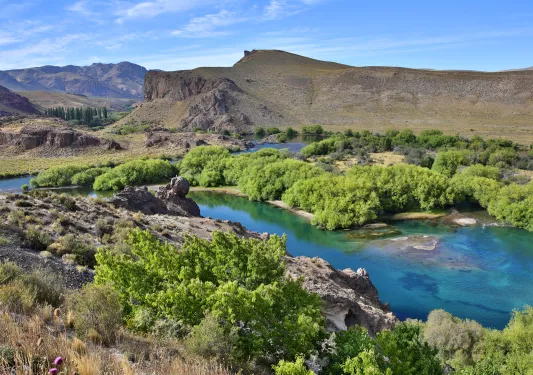 Open valley with a river flowing between two plots of land
