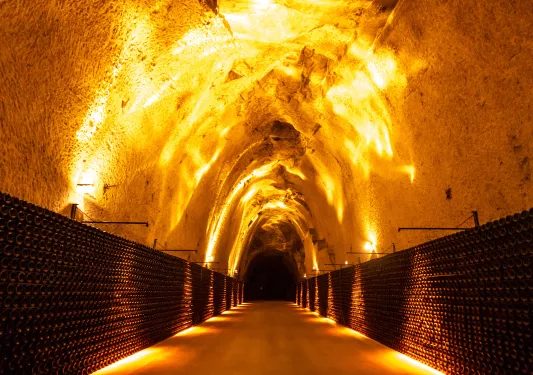 Underground cave walkway illuminated by orange lights