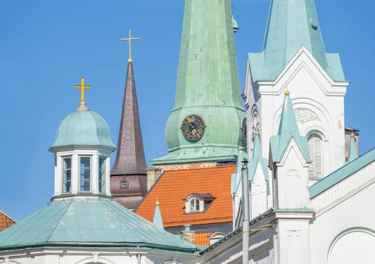 Blue and white church building with large crosses on top