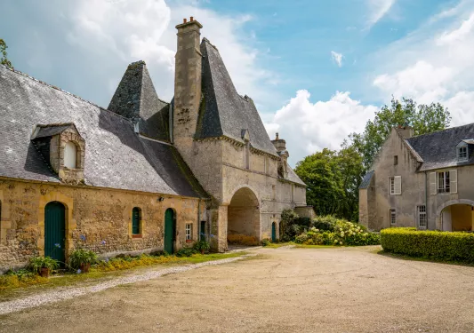 Rustic, stone church building with a dirt valley in front