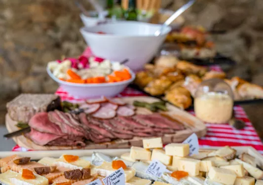 Wooden planks full of cheese and cured meats