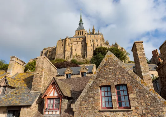 Stone, castline like buildings with cloudy skies above