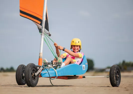 Girl sitting on a wheel raft, wearing a helmet