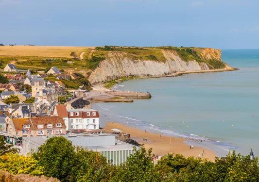 Small town next to a beach and large cliffs