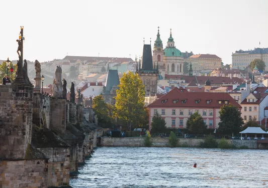 Large river and a stone bridge leading to a small town