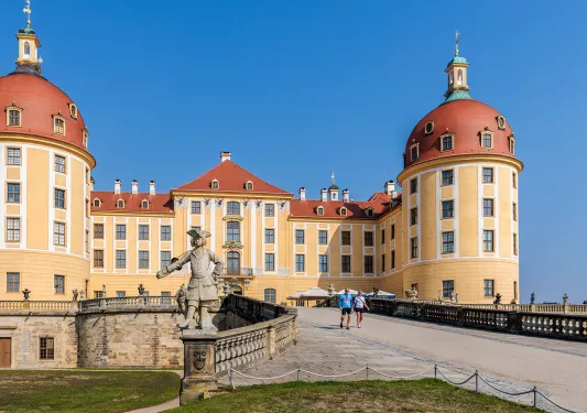 Exterior view of yellow and brown cathedral-like building