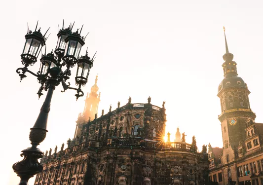 Exterior view of cathedral-like building with the sunset in the background