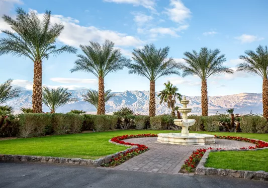 Courtyard with a stone fountain and grass area